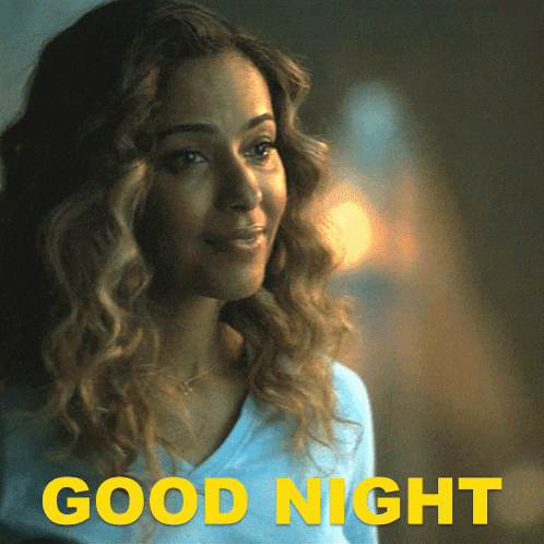 a woman with curly hair says good night