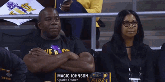 a man wearing a black shirt that says magic johnson
