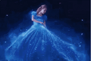 a woman in a blue dress is dancing in the dark