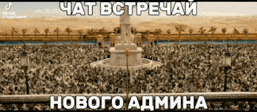 a large crowd of people are gathered around a fountain in a foreign language .