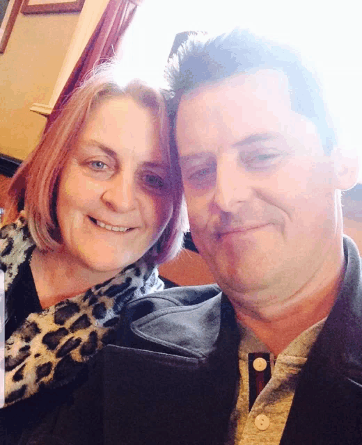 a man and woman are posing for a picture together