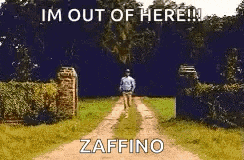 a man is walking down a dirt road with a sign that says `` im out of here ! ''