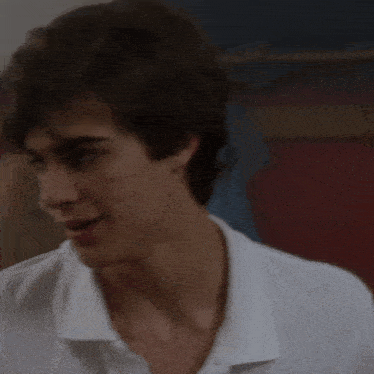 a close up of a man 's face with a white shirt