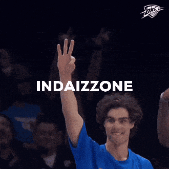 a man wearing a blue thunder shirt holds up his hand