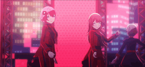 three anime girls are standing next to each other on a stage in front of a city skyline .