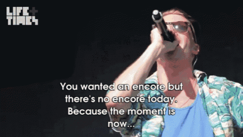 a man singing into a microphone with the words " you wanted an encore but there 's no encore today " written below him