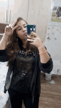a girl is taking a picture of herself in a mirror