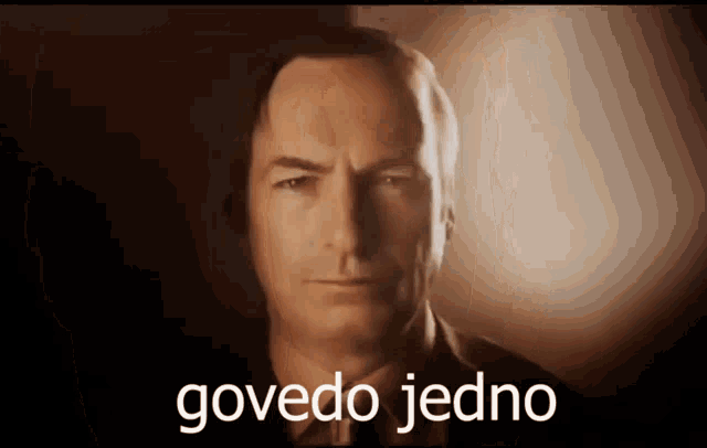 a close up of a man 's face with the words govedo jedno written below it
