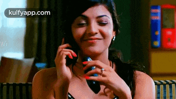 a woman is talking on a cell phone and smiling .