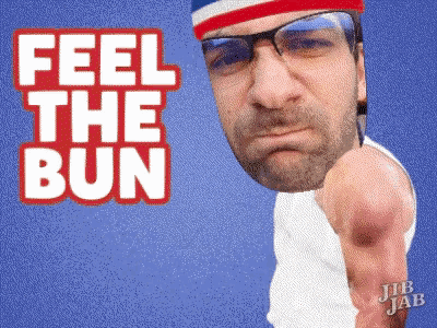 a man with glasses and a red white and blue headband is pointing at the camera with the words feel the bun behind him