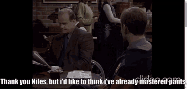 a man sits at a table talking to another man with the words thank you niles