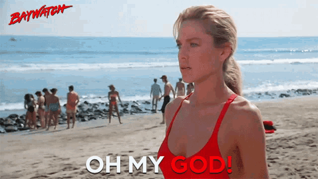 a woman in a red bathing suit stands on a beach with the words oh my god