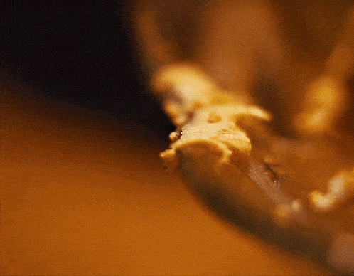 a close up of a piece of peanut butter in a glass bowl
