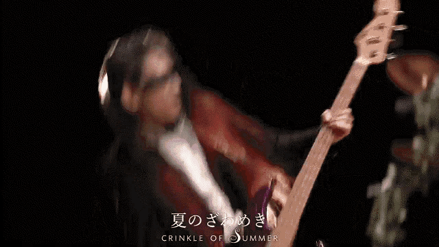a person holding a pink guitar with the words crinkle of summer on the bottom right