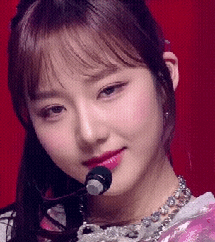 a close up of a woman 's face with a microphone in her ear