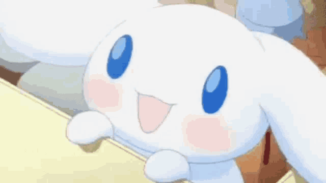 a close up of a white bunny rabbit with blue eyes and a smile on its face .