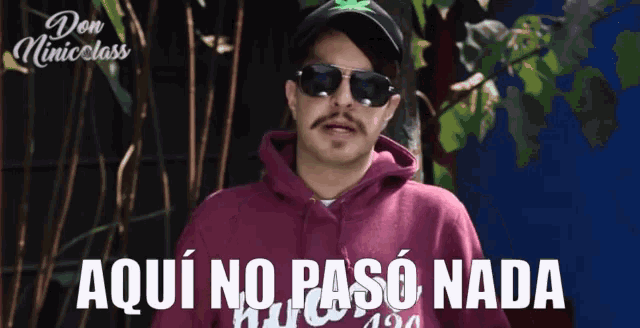 a man wearing sunglasses and a purple hoodie says aqui no paso nada