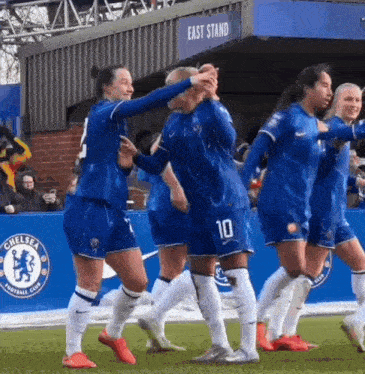 a group of female soccer players from the chelsea soccer club are celebrating a goal
