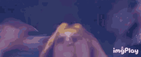 a close up of a person 's face with a purple background and the words imgplay in the lower right corner .