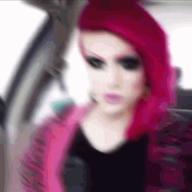 a blurry image of a woman with red hair