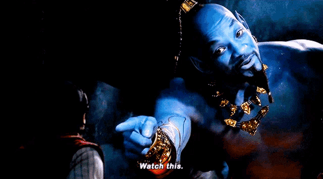a man with blue skin and gold jewelry is pointing at someone and says watch this