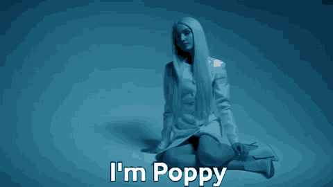a woman sitting on the floor with the words i 'm poppy written above her