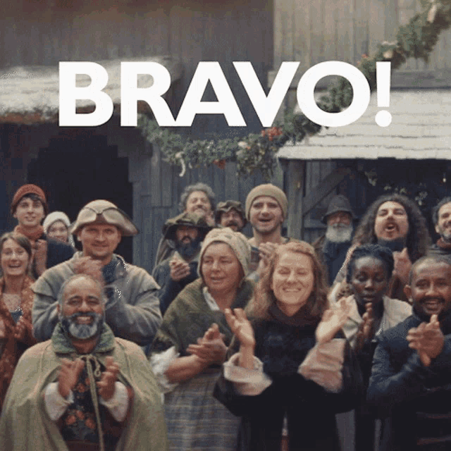 a group of people are clapping in front of the word bravo