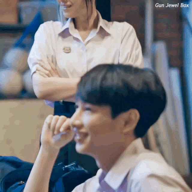 a girl in a white shirt stands next to a boy in a white shirt with gun jewel box written on the bottom