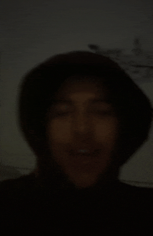 a blurry picture of a man wearing a black hat