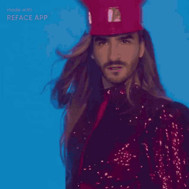 a man with long hair is wearing a red top hat