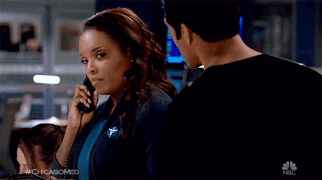 a woman talking on a phone next to a man with the chicagomed logo on the bottom