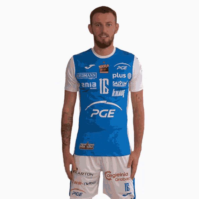 a man wearing a blue and white pge shirt and shorts