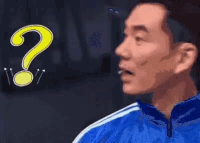 a man in a blue jacket has a yellow question mark above his head .
