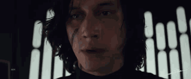 a close up of a man 's face with a feather on it .