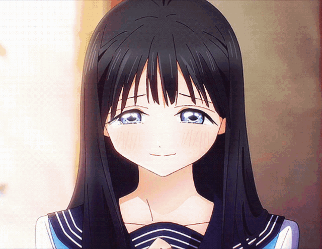 a girl with long black hair and blue eyes smiles for the camera