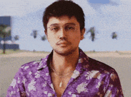 a man wearing a purple floral shirt and glasses is standing on a beach .