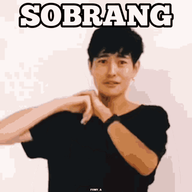 a man in a black shirt is making a heart shape with his hands and the word sobrang is above him