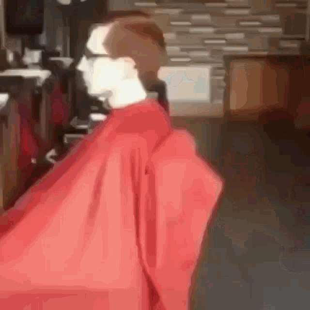 a man is getting his hair cut in a barber shop .
