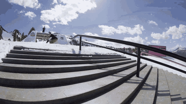 a snowboarder is doing a trick on a ramp with a sign that says ' a ' on it