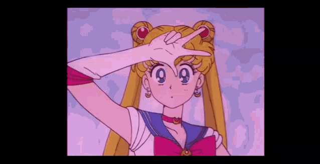 sailor moon is wearing a sailor suit and making a peace sign .
