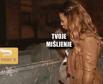 a woman in a brown jacket is standing in front of a sign that says " tvoje mislinje "