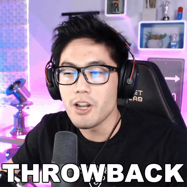a man wearing glasses and headphones says " throwback " in front of a microphone