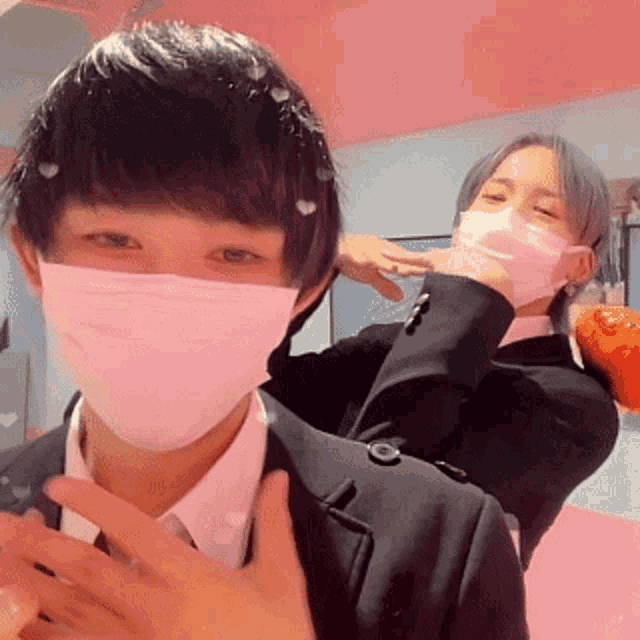 a man wearing a mask is standing next to another man wearing a mask