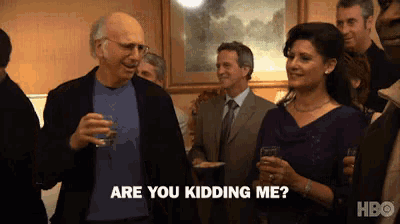 a man and a woman are standing in a crowd and the man is asking the woman if she is kidding him
