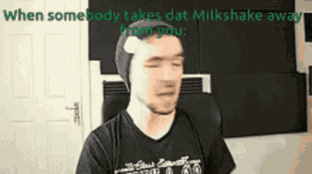 a man wearing a beanie and a black shirt says when somebody takes dat milkshake away from you