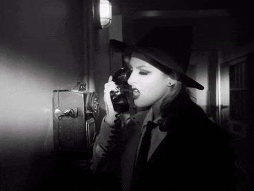 a woman with a tattoo on her arm talking on a telephone