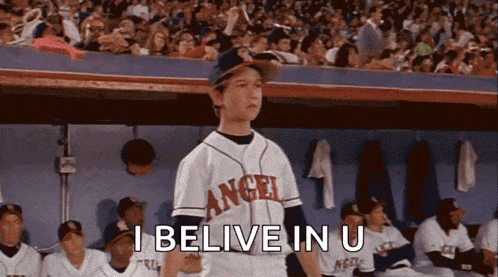 a boy in a baseball uniform with the word angel on it
