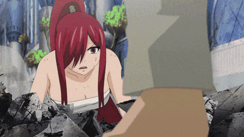 a woman with red hair is laying on a pile of rocks and looking at something