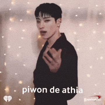 a man in a black jacket is making a funny face with the words piwon de athia written on the bottom