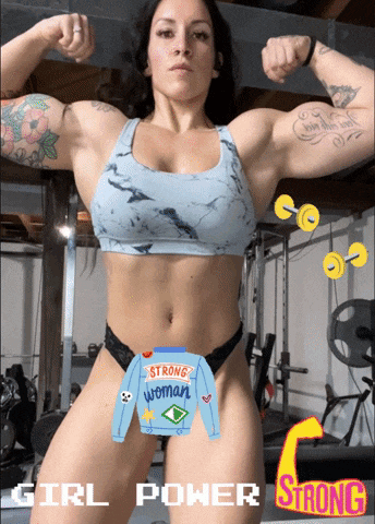 a woman flexes her muscles in a gym with a sweater that says strong woman